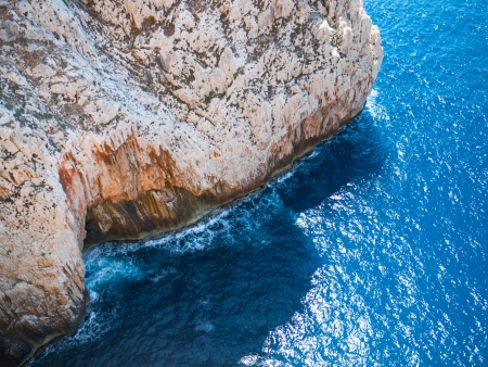 Top view on waves hitting the reefの写真素材