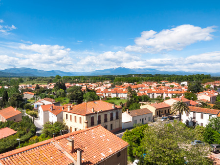 Residential area with tiled roofs and  mountains in the backgroundの写真素材