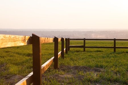 Close up view of wooden fence in grassy landscape