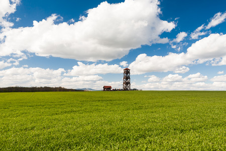 Lookout tower Radosinka with many visitors located on the top of a hill under blue sky with beautiful cloudsの写真素材