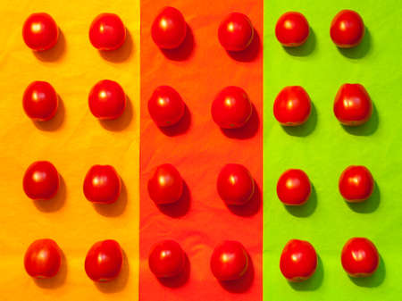 Pattern with red natural tomatoes on a colored background. Ripe and healthy vegetablesの写真素材