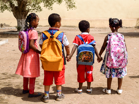 Djibouti / Africa - September 14 2015 : School students with bag packs holding hands and going to schoolのeditorial素材