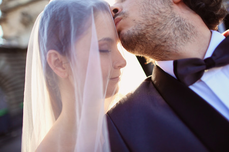Close up of a bride and groom in the sunlightの写真素材