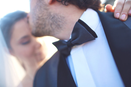 Close up of a bride and groom in the sunlightの写真素材