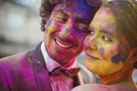 Bride and groom in the city with holi powderの写真素材