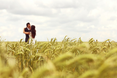 Bride and Groom posing in the fieldsの写真素材