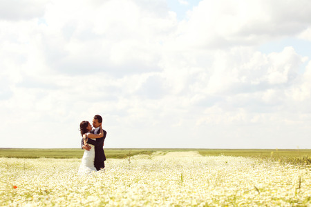 Bride and Groom posing in the fieldsの写真素材