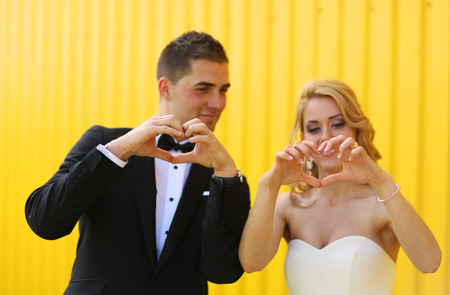 Bride and groom on a yellow backgroundの写真素材