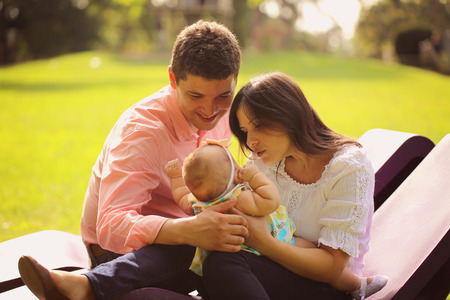 Affectionate parents with their baby girl in the park