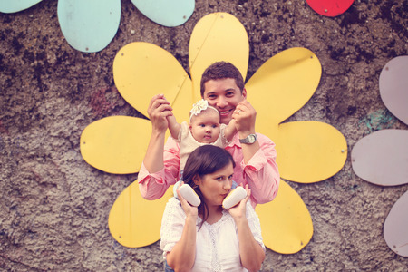 Playful parents with their baby girl in the parkの写真素材