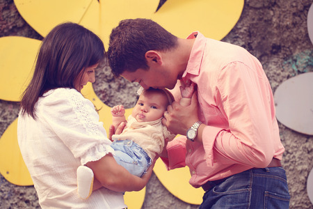 Playful parents with their baby girl in the park