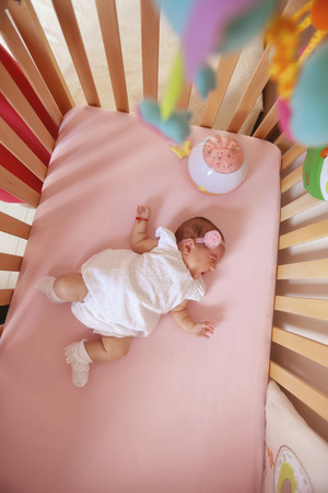 Beautiul baby girl in her bedの写真素材