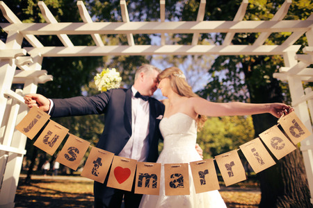 Couple holding Just Married signsの写真素材