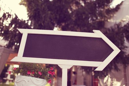 A wedding reception sign is made from a small chalkboard