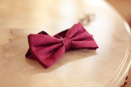 Pink bowtie on tableの写真素材