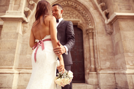 Bride and groom in front of a churchの写真素材