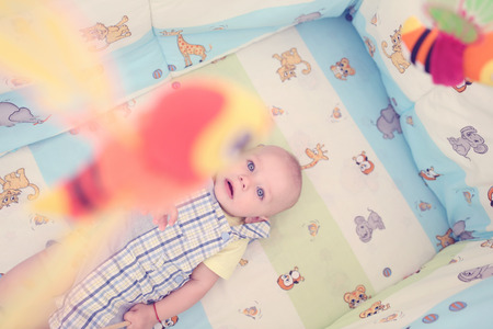 Playful kid in his bed