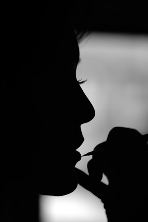 Silhouette of woman at make up artistの写真素材