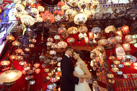 Bride and groom surrounded by turkish lampsの写真素材