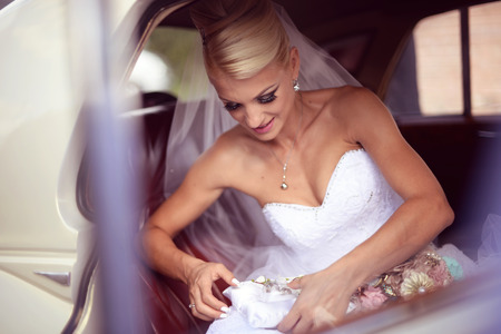 Beautiful bride waiting in the carの写真素材