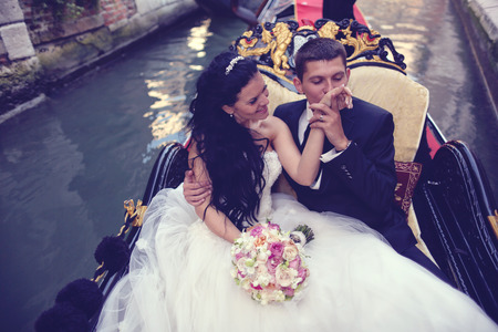Bride and groom in Venice, in a gondolaの写真素材