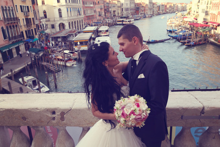 Bride and groom on a bridge in Veniceの写真素材