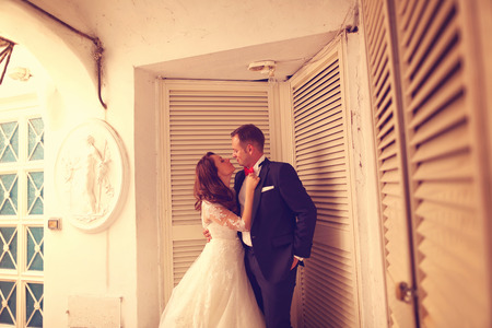 Bride and groom near old houseの写真素材