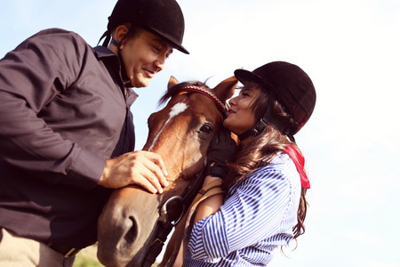 Couple playing with a horse
