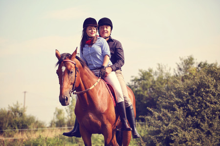 Couple riding a horse