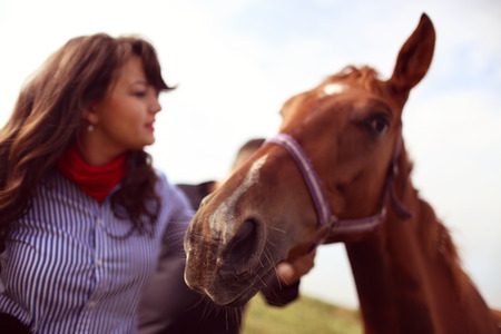 Happy couple with their horseの写真素材