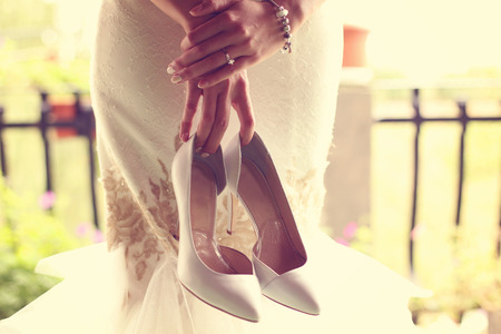 Bride holding her shoesの写真素材