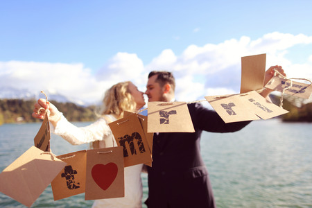 Bride and groom playing with Just Married cardsの写真素材