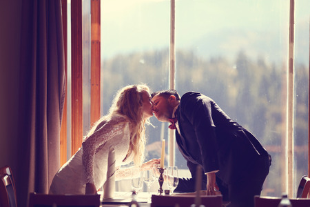 Affectionate bride and groom in the restaurantの写真素材