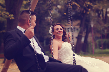 Bride and groom in a swingの写真素材