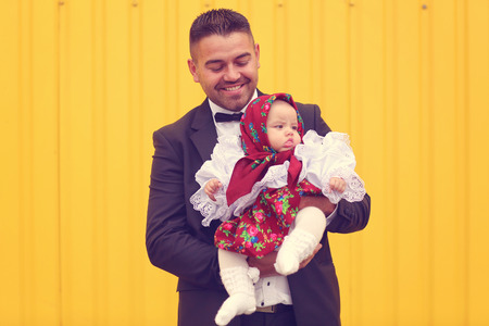 Handsome father holding her baby girlの写真素材