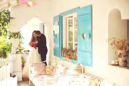 Bride and groom near beautiful vintage houseの写真素材