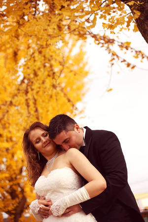 Bride and groom on autumn dayの写真素材