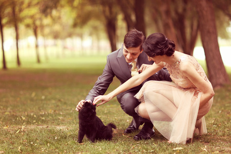 Couple playing with black catの写真素材