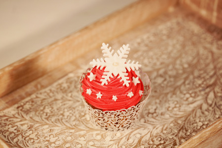 Red cupcake on wooden plateの写真素材
