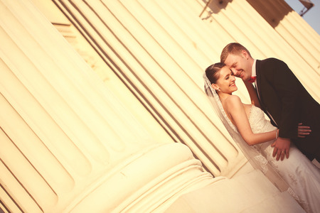 Bride and groom near columnsの写真素材