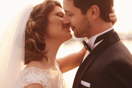 Close up of a bride and groom embracingの写真素材