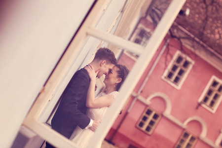 Bride and groom embracing in the cityの写真素材