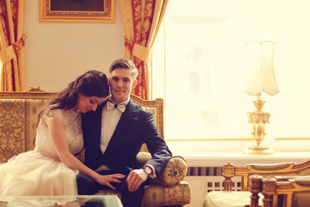 Bride and groom in a hotel roomの写真素材