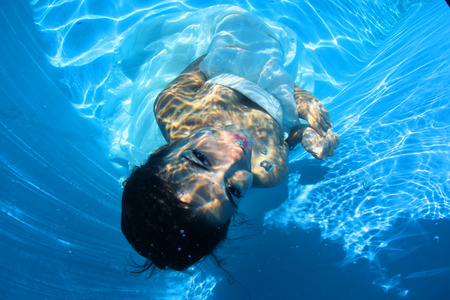 Fantasy bride underwater in a bird cageの写真素材
