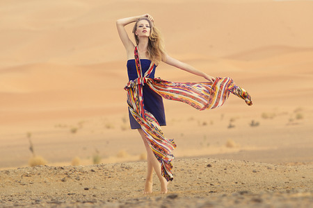 Portrait of a beauty woman in a dress in the hot desertの写真素材