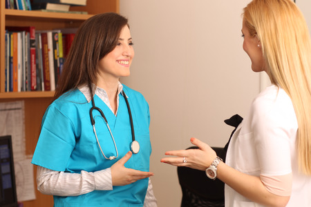 two female doctors chatting at workの写真素材