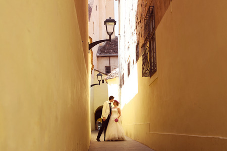 Bride and groom on a narrow streetの写真素材