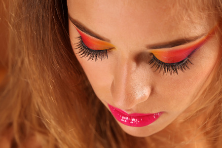 Beautiful woman wearing colorful make up in the studioの写真素材