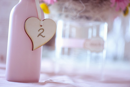 Beautiful bouquet in bottle with table numberの写真素材