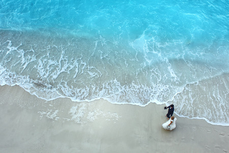 Bride and groom at the beachの写真素材